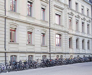 Viele Fahrräder neben dem Hauptgebäude.